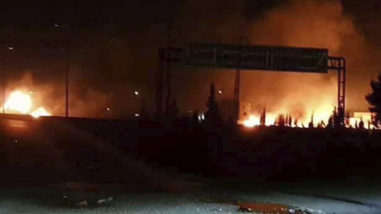 This photo released on Wednesday, May 9, 2018, by the Syrian official news agency SANA, shows flames rising after an attack in an area known to have numerous Syrian army military bases.