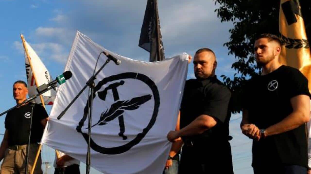 Leaders of a new Hungarian group unveil the flag for their new movement, Force and Determination