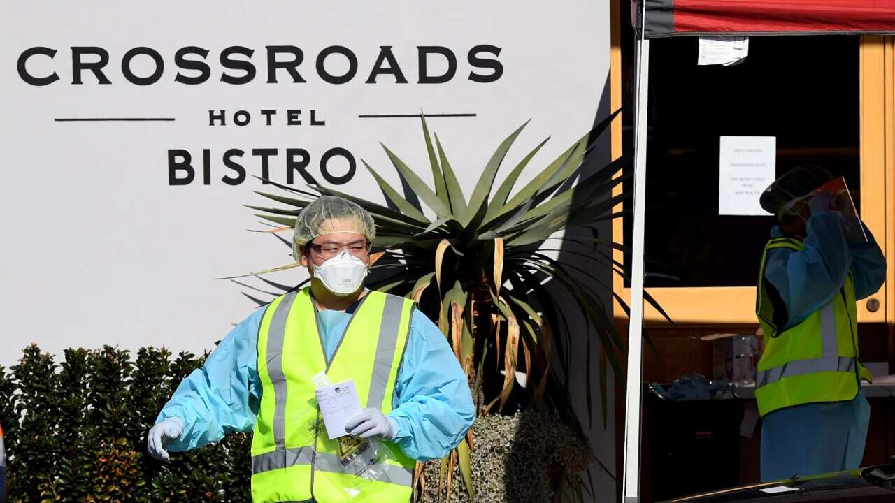 Health workers outside the Crossroads Hotel in Sydney, Monday, July 13, 2020.