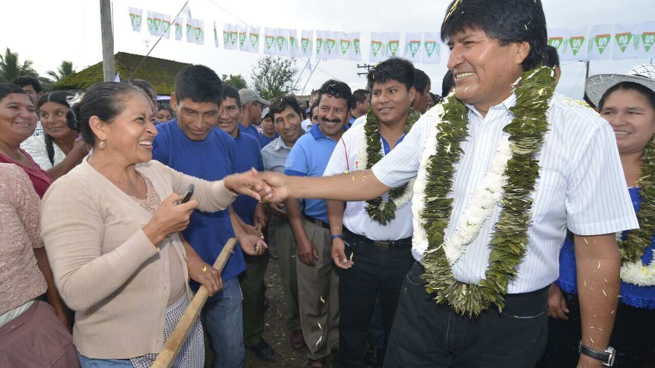 President of Bolivia Evo Morales greets a supporter before casting his vote.