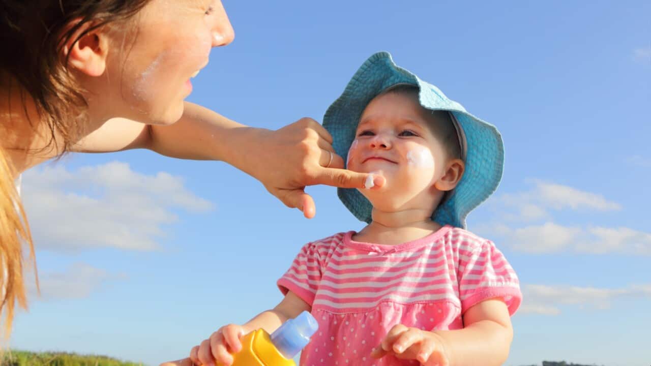 Mother applying sunscreen to a child