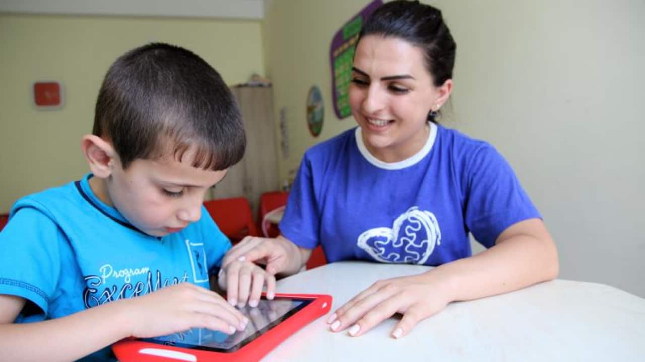 A child using interactive learning games designed for children on the autism spectrum.