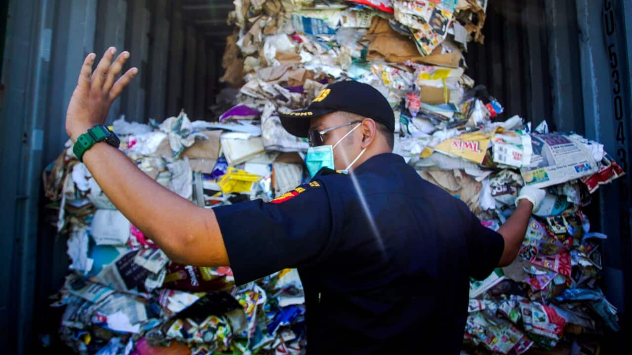 Indonesian officials inspect waste from Australia.