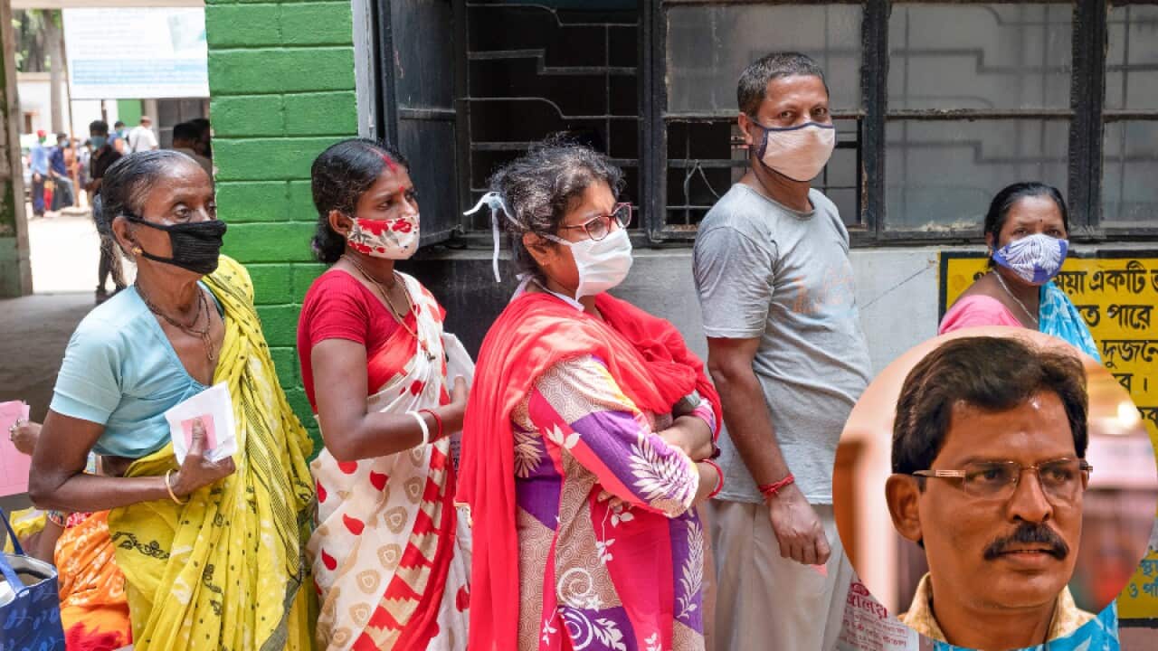 People stand in a queue for coronavirus testing at Madhyamgram rural hospital