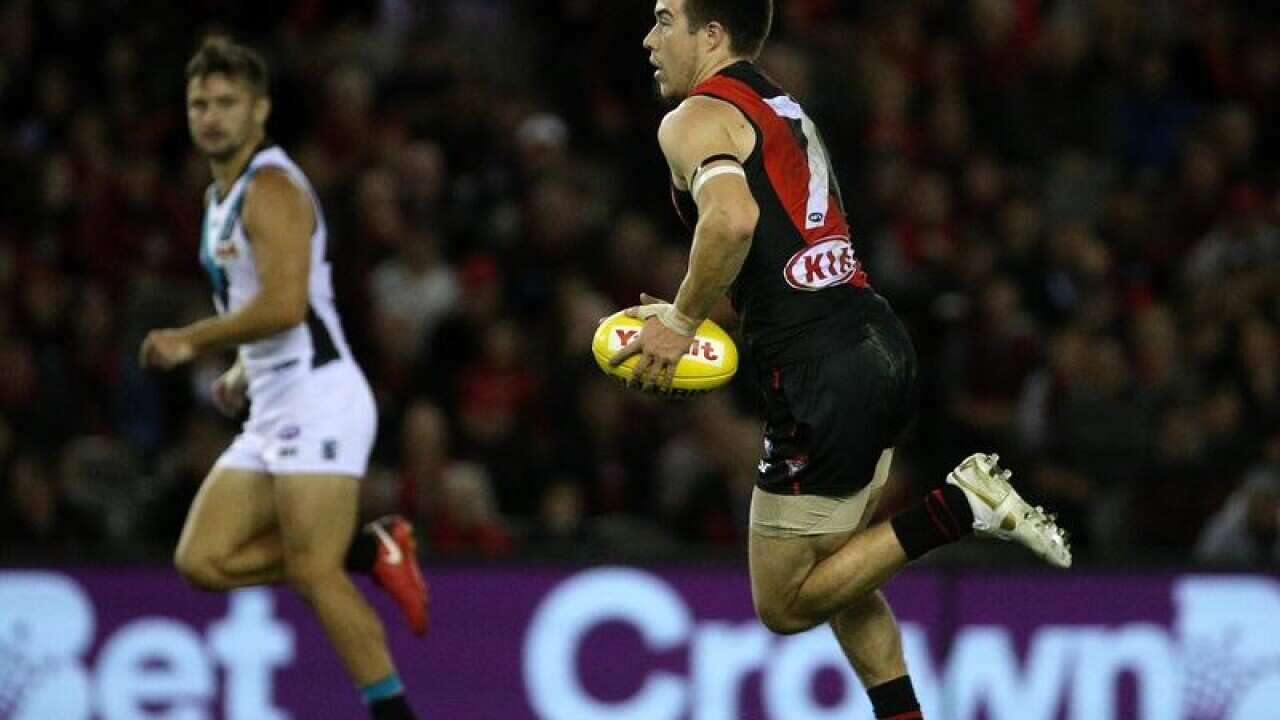 Zach Merrett of the Bombers runs forward during the Round 4.