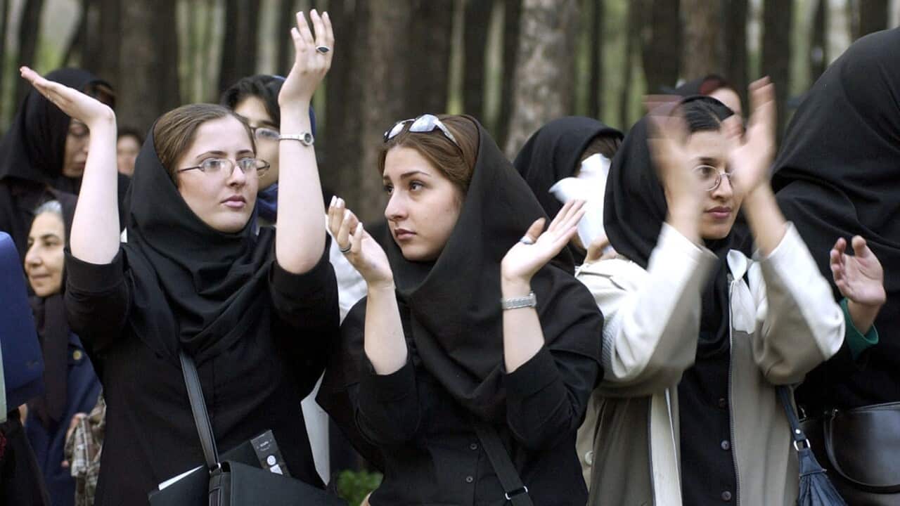 Iranian women clap their hands, while attending a rally to celebrate International Woman's Day in Tehran, Monday March 8, 2004.(AP Photo/Hasan Sarbakhshian)