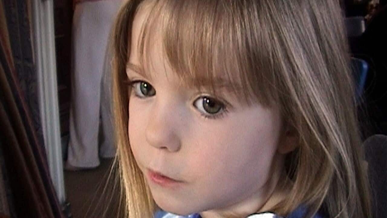 A young girl with a neutral facial expression.