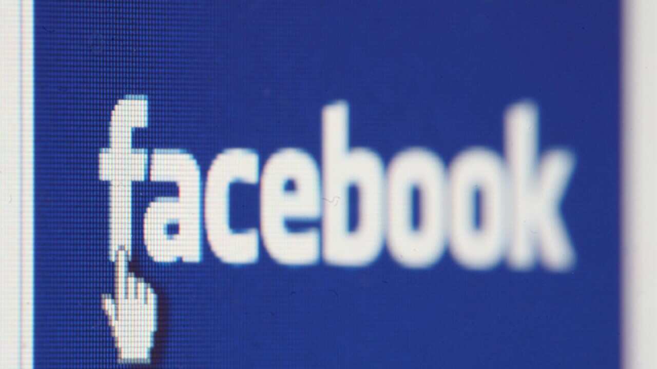 The Facebook icon displayed on a laptop