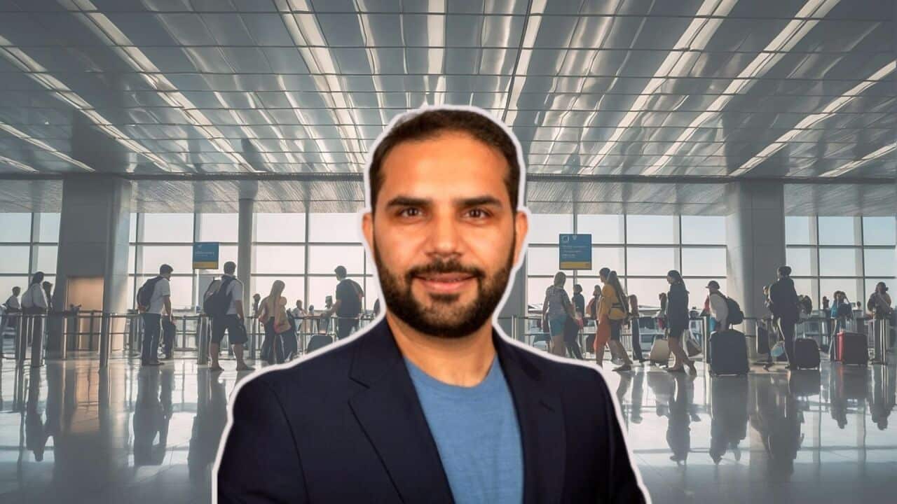 Image of visa expert Kunal Tanjea superimposed on a background of an airport with people moving from one terminal to another.