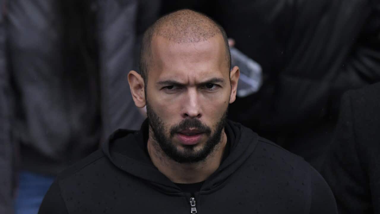 A bald man in a black hoodie