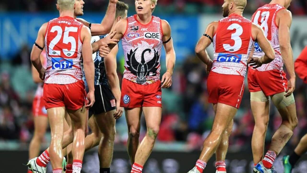 Isaac Heeney of the Swans (centre) celebrates.
