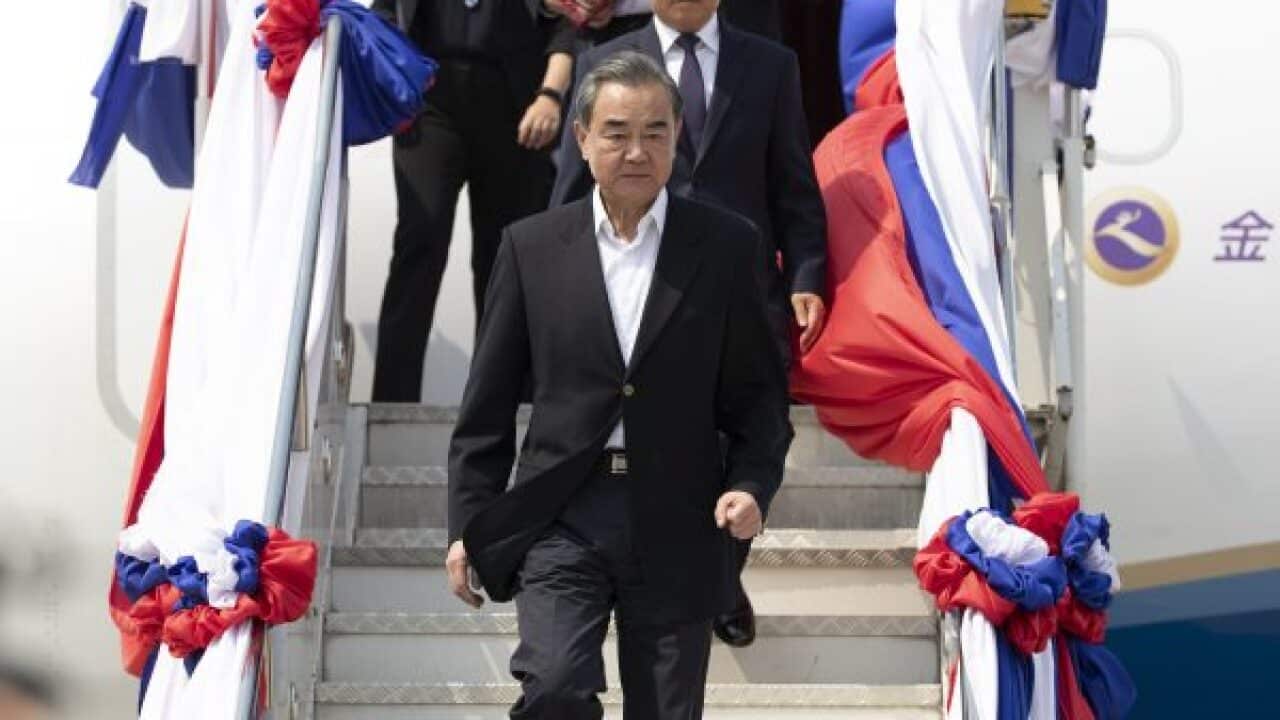 China’s Foreign Minister Wang Yi arrives at Wattay Airport