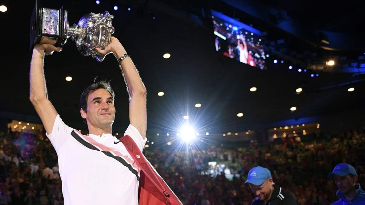 Switzerland's Roger Federer holds his trophy aloft after defeating Croatia's Marin Cilic during the men's singles final at the Australian Open tennis championships in Melbourne, Australia, Sunday, Jan. 28, 2018. (AP Photo/Andy Brownbill)