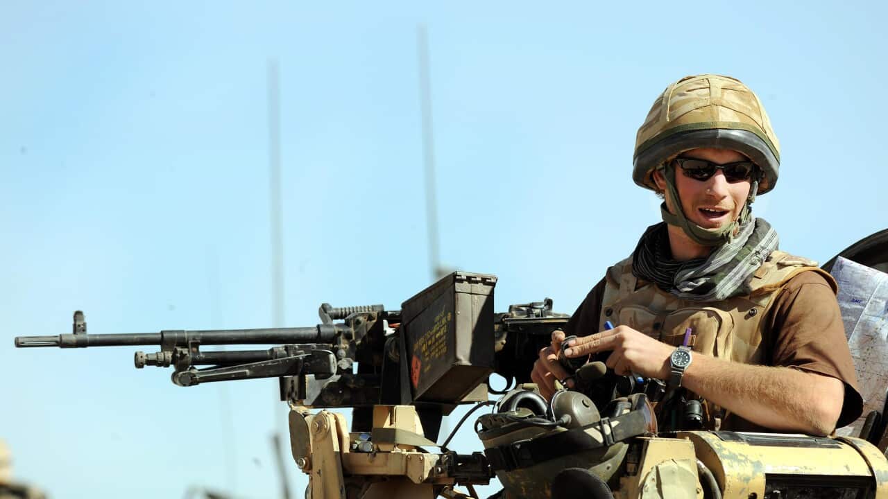 A man sitting on an armoured vehicle.