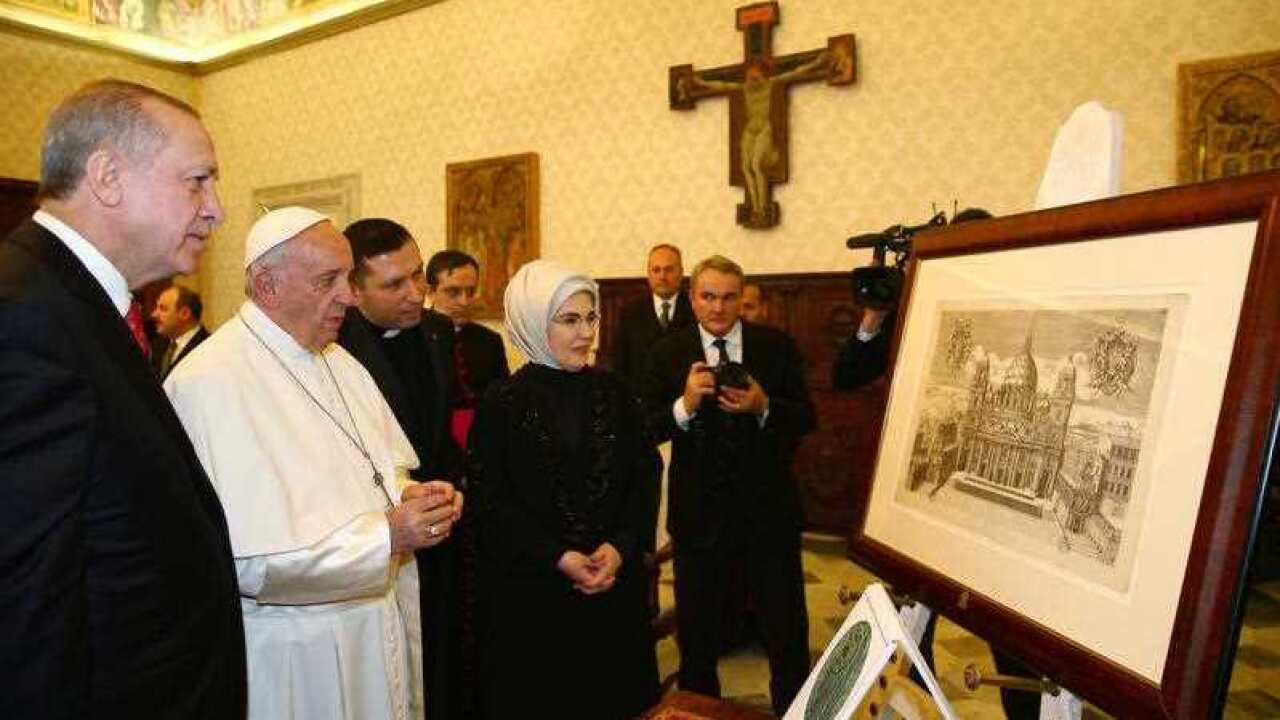 Turkish President Recep Tayyip Erdogan, left, and his wife Emine Erdogan, right, meet Pope Francis at the Vatican.