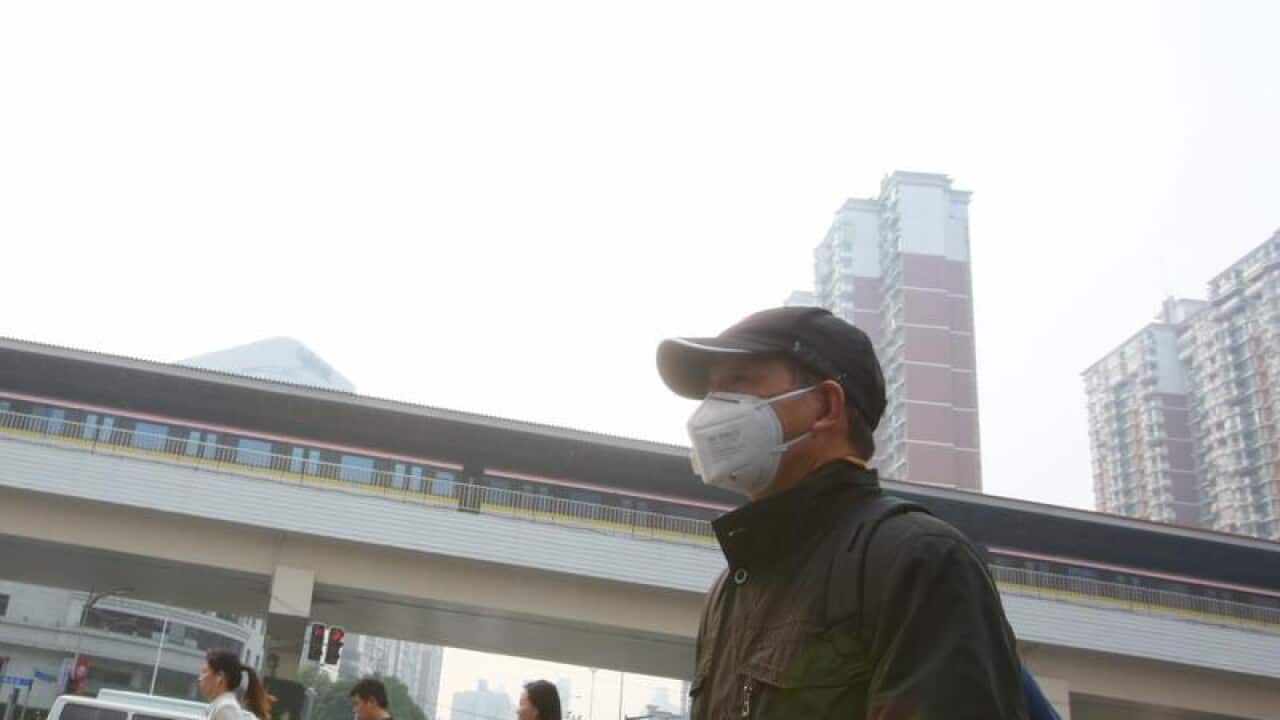 A pedestrian wearing a face mask against air pollution