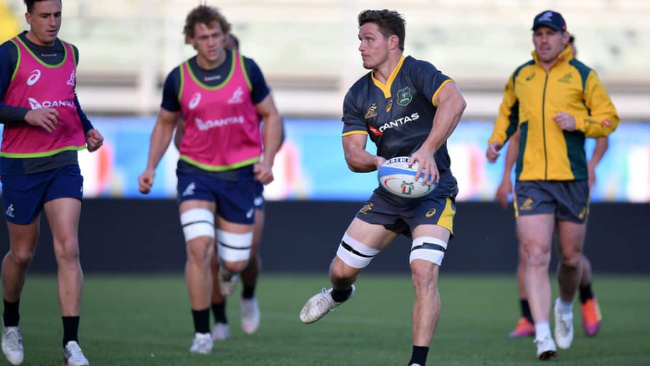Wallaby Michael Hooper passes the ball at training
