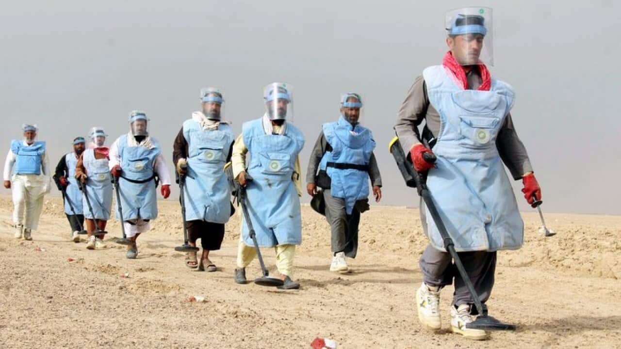 Afghan workers prepare to search for landmines in Kandahar, Afghanistan