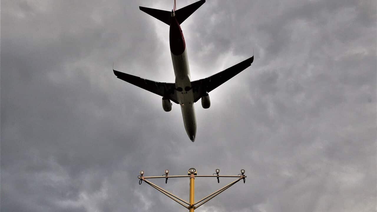 A passenger plane prepares to land at Sydney Airport,