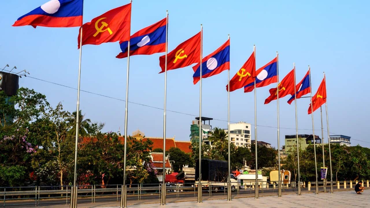 Laotian and Communist flags on a square in Vientiane (MLADEN ANTONOV/AFP via Getty Images)