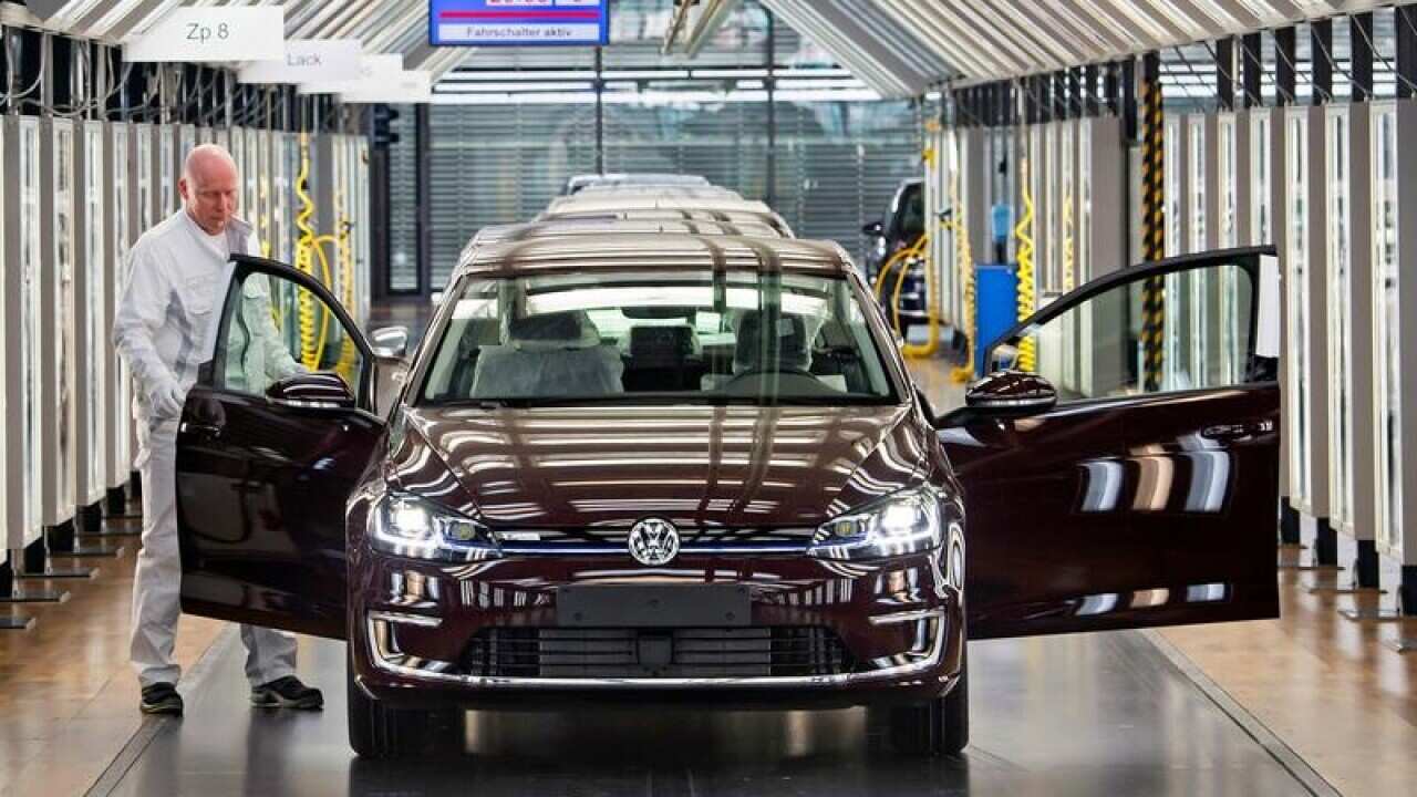 A file image of Roland Schulz and an e-Golf electric car in Germany.