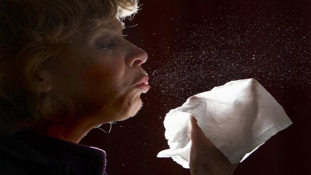 A woman sneezing.