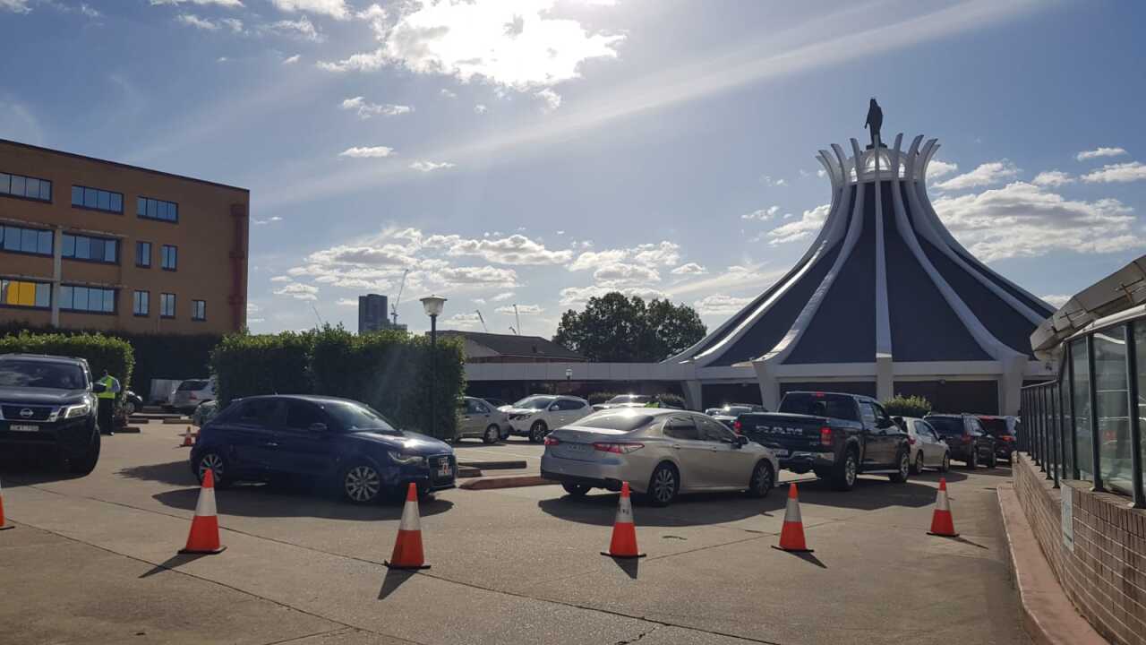 Cars in line to do Corona test in Lady of Lebanon Church in Sydney.
