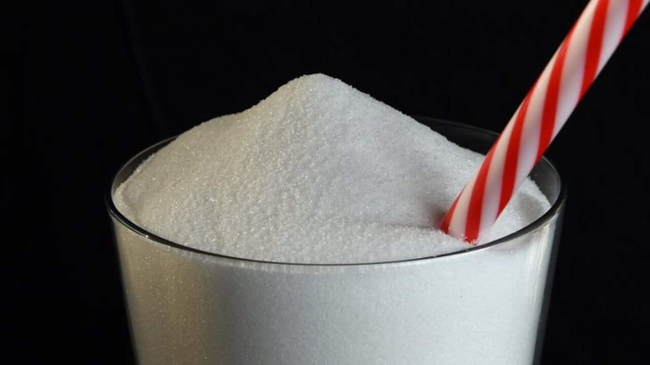 A stock image of white sugar in a glass with a drinking straw, Friday, Aug. 19, 2016. (AAP Image/Dan Peled) NO ARCHIVING