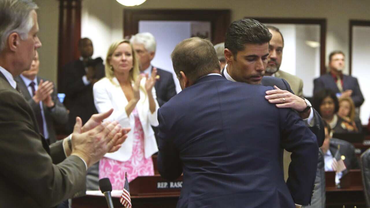 Rep. Jose Oliva, R- Miami Lakes, is hugged and congratulated by House members as the gun/school safety bill passed the Florida House 67-50. 
