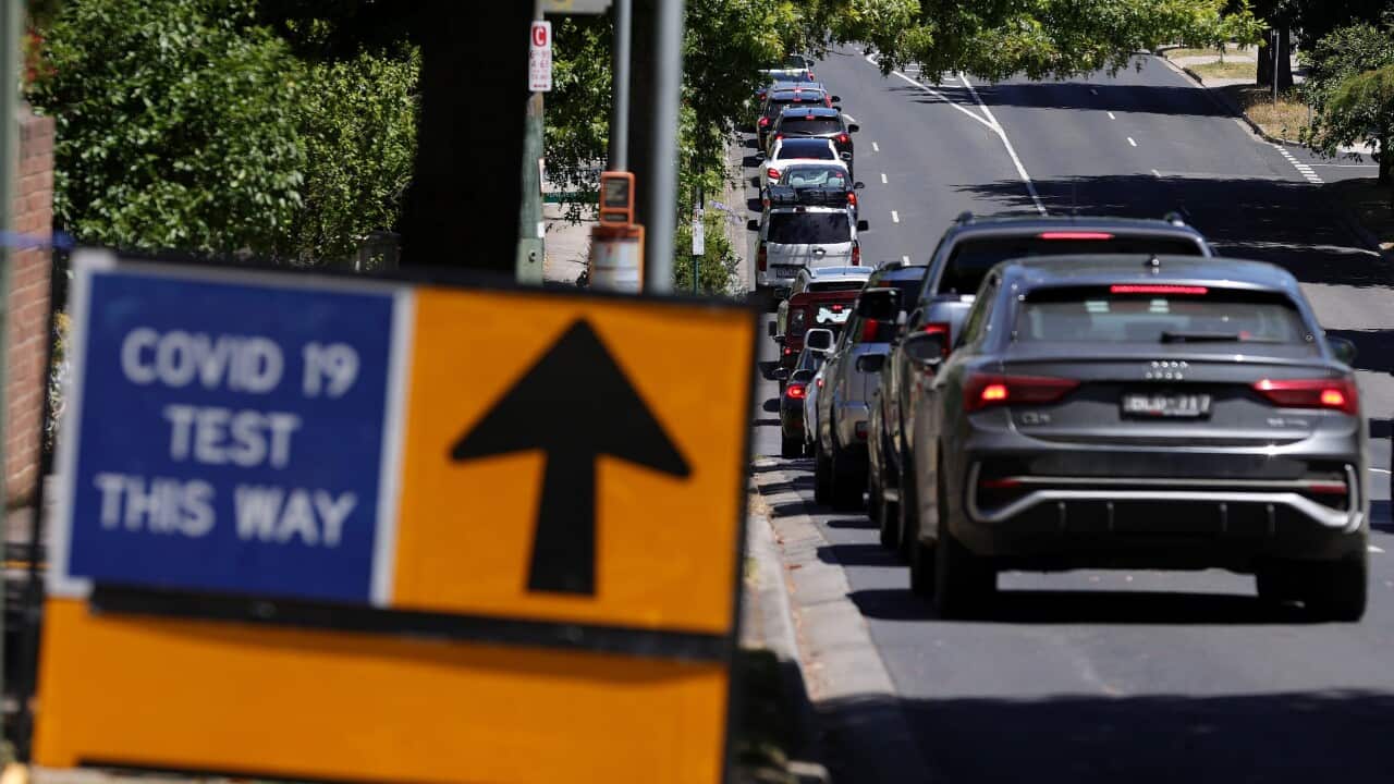 Members of the public are seen queuing in their cars on Elgar Road at a drive-through COVID-19 testing site.