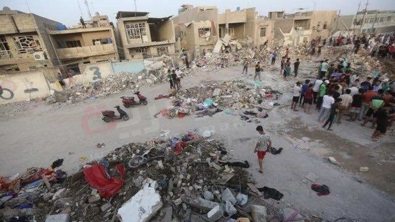 Iraqis inspect the aftermath of an explosion in Baghdad's Sadr City district on June 7, 2018.