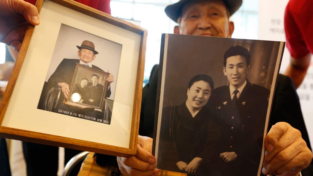A South Korean separated family member holds a his family pictures to give his North Korean family.