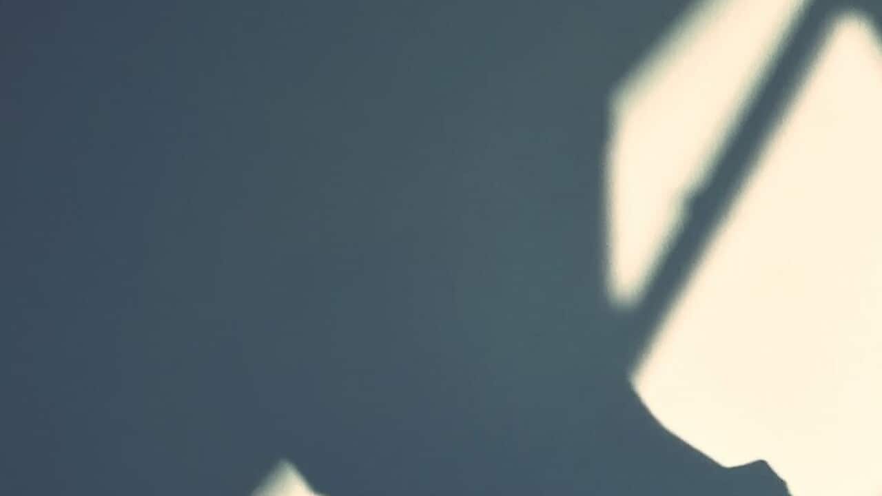 Man Standing Against Wall