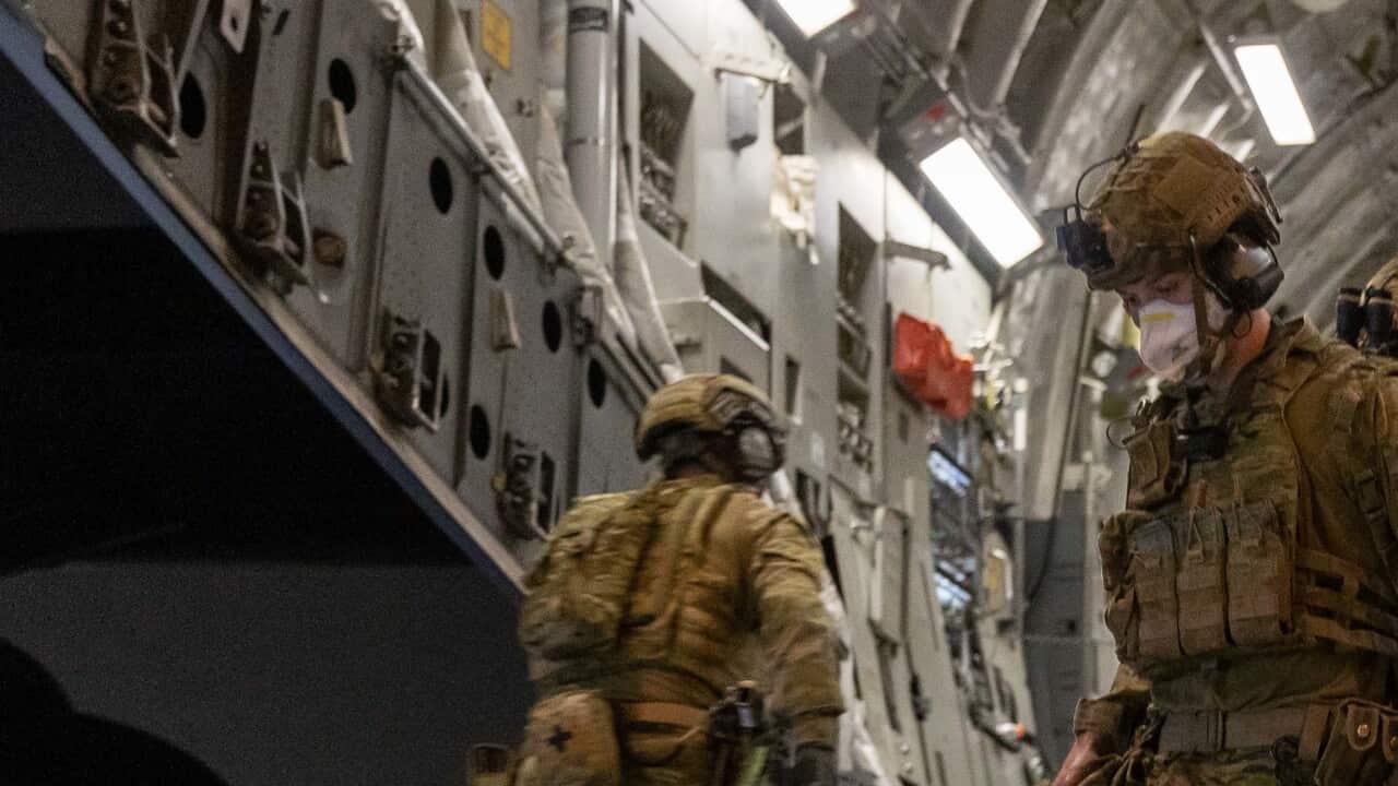 Australian Defence Force personnel unloading luggage from a Royal Australian Air Force C-17A Globemaster in the Middle East.