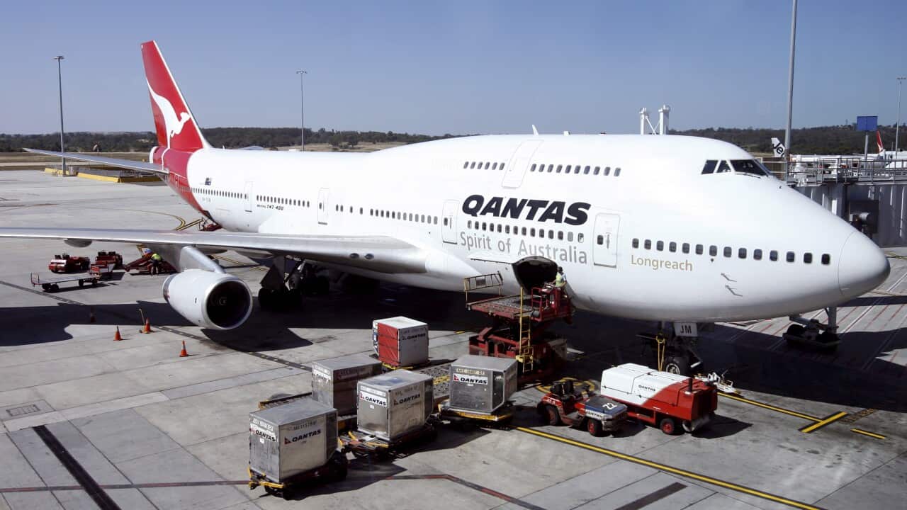A Qantas airlines jumbo jet is loaded before departure at Tullamarine Airport in Melbourne, Australia.