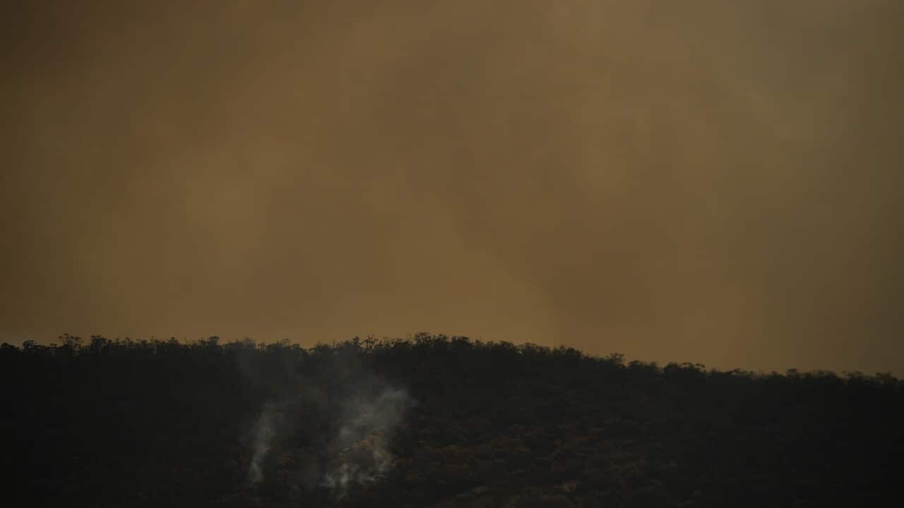 Smoke from a bushfire burning behind a ridge near the town of Tharwa, 30km south of Canberra, on 30 January 2020.