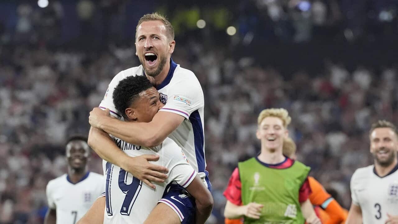 England's Harry Kane celebrates in the arms of teammate Ollie Watkins at the end of a semifinal match against Netherlands (AAP)
