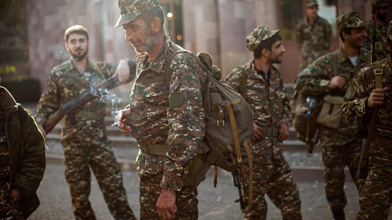 Ethnic Armenian volunteer recruits gather at a center to receive their uniforms