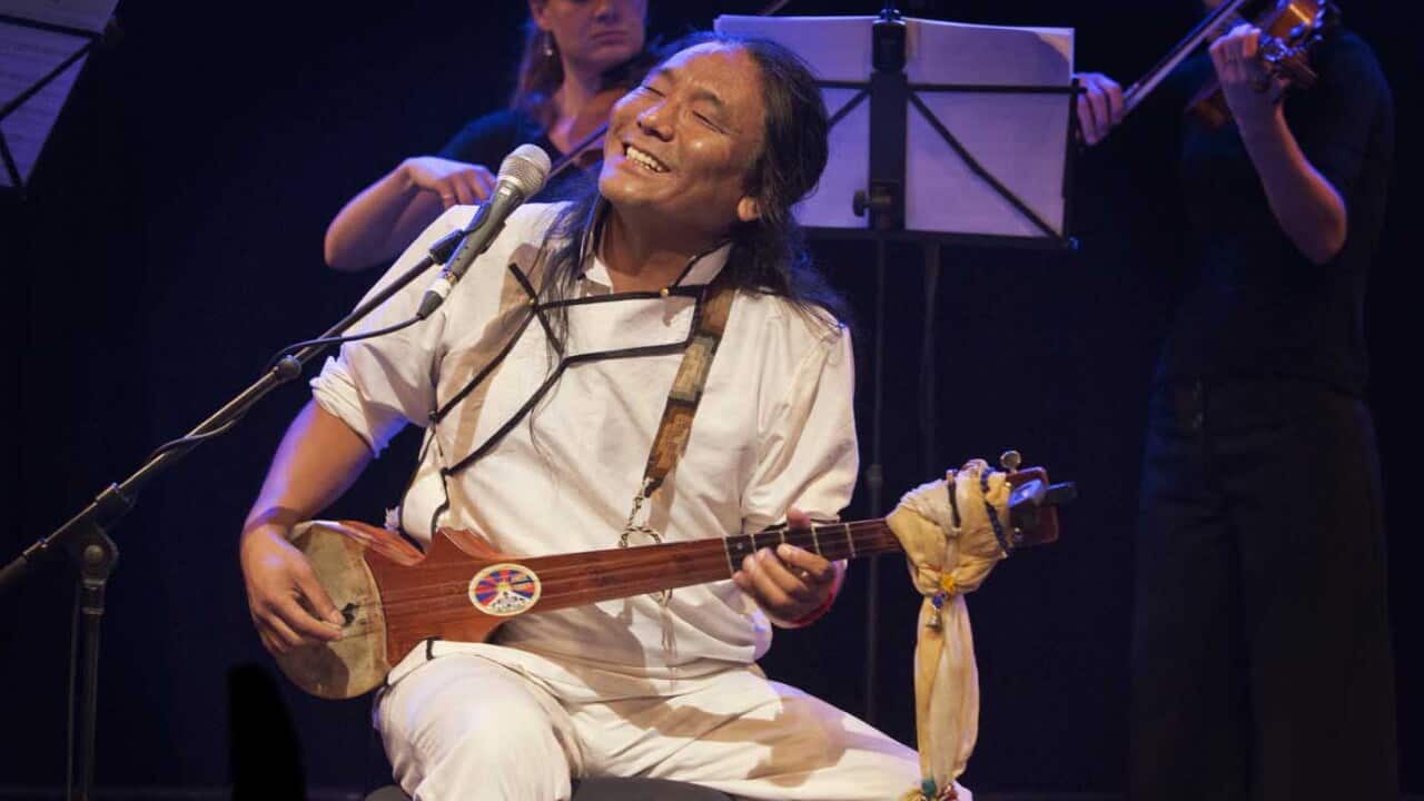 Tenzin Choegyal is seen playing Tibetan traditional string instrument, dra-nyen.