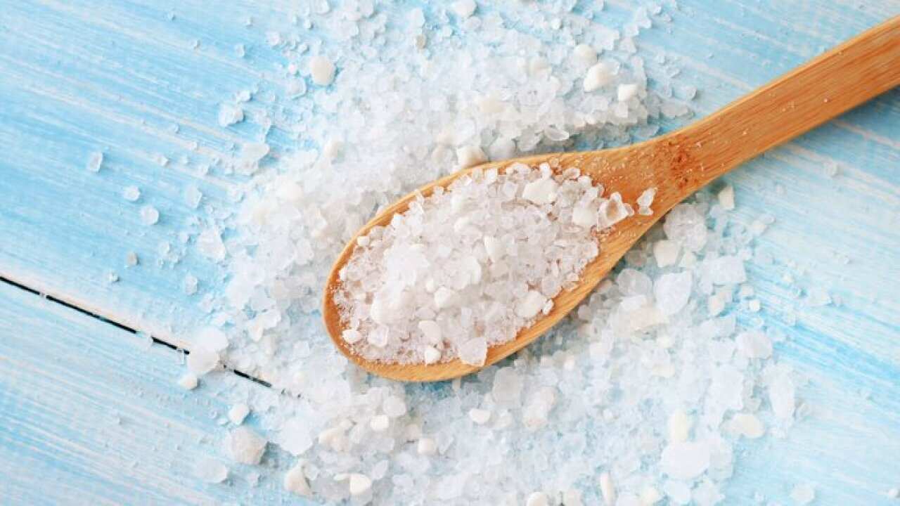 Sea salt on wooden table wooden spoon