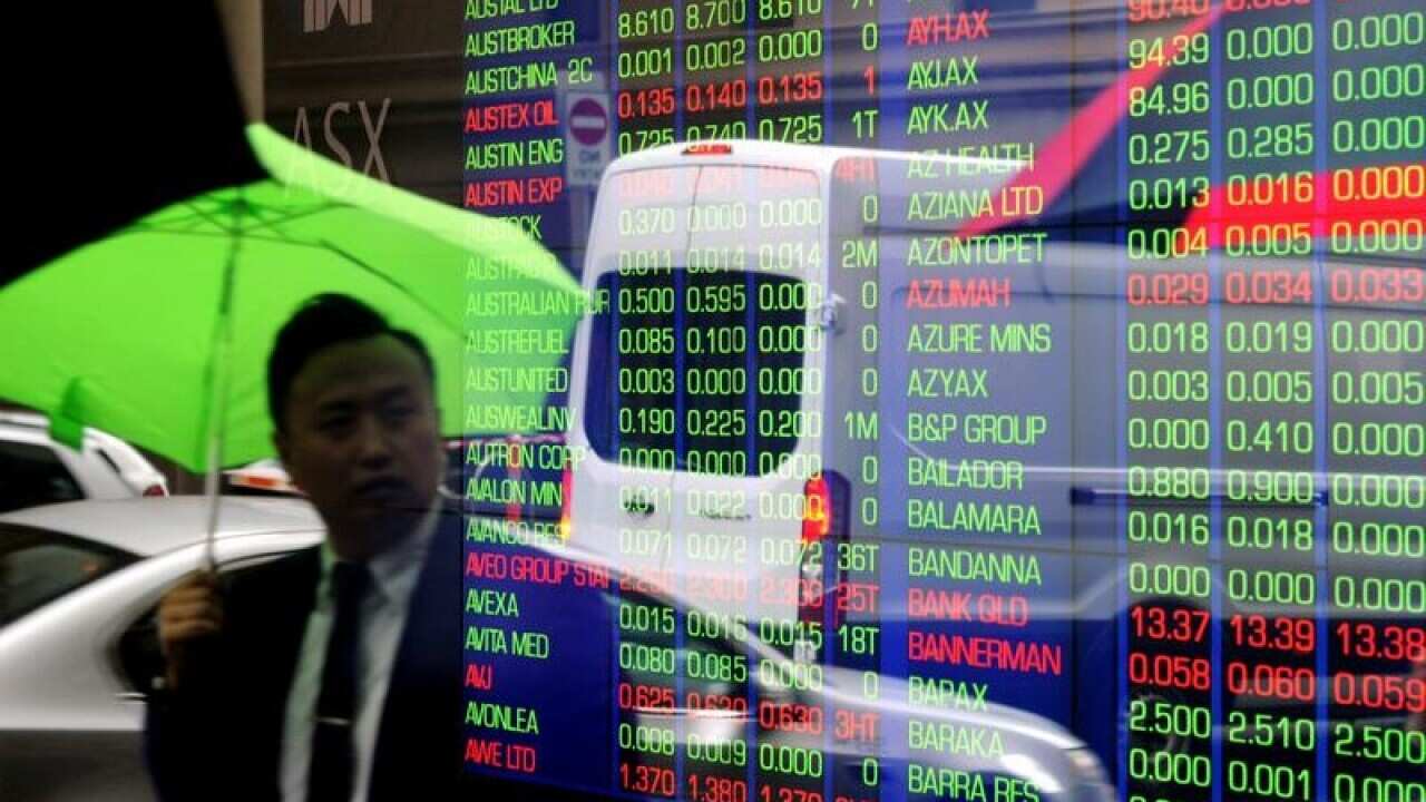 Pedestrians reflected in window at ASX.