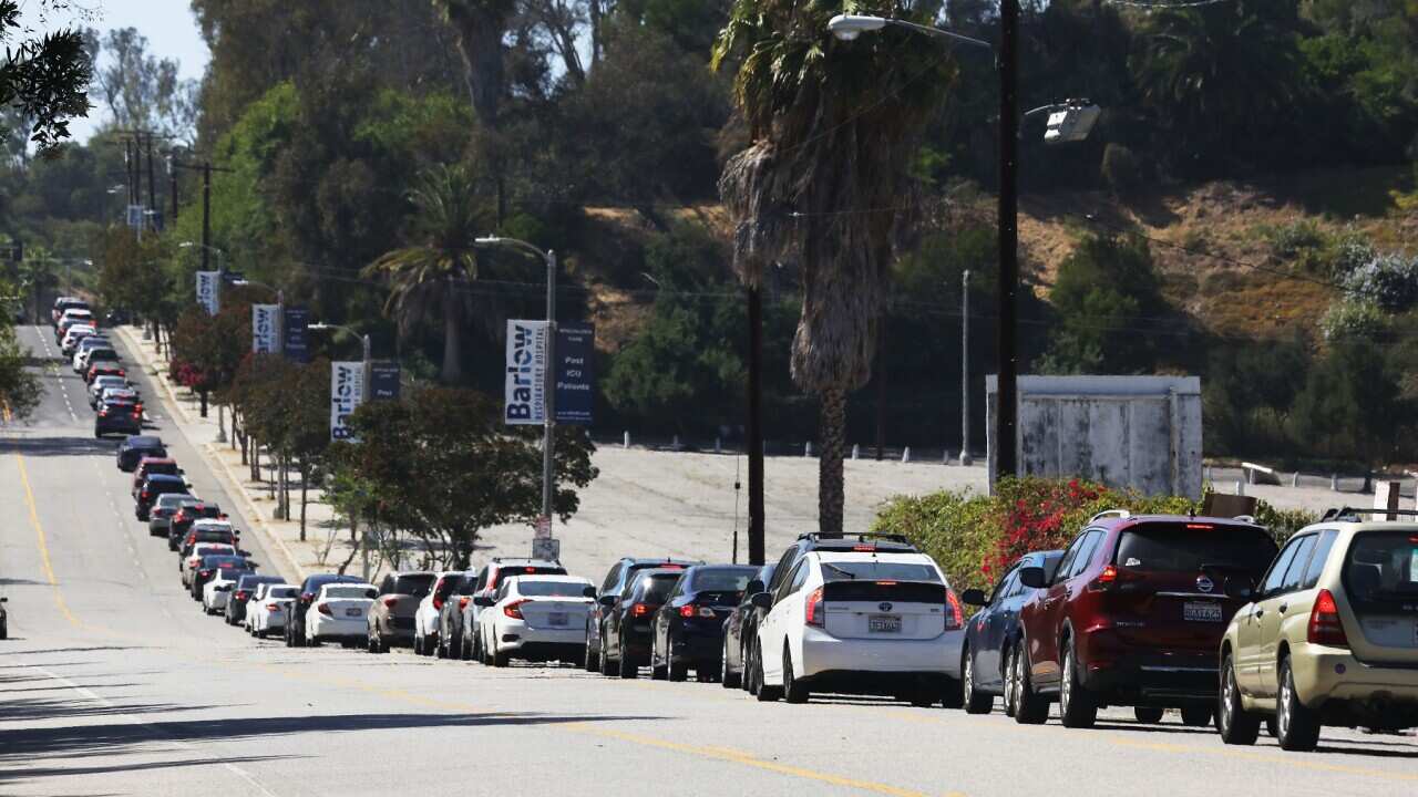 Motorists wait in line to enter the COVID-19 testing centre at Dodger Stadium in Los Angeles