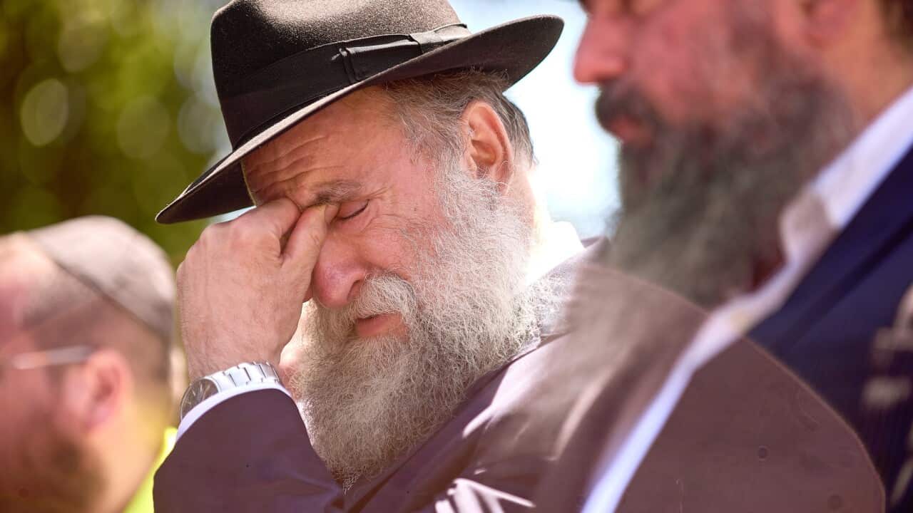 Mourners attend the funeral service for Rabbi Eli Schlanger (AAP)