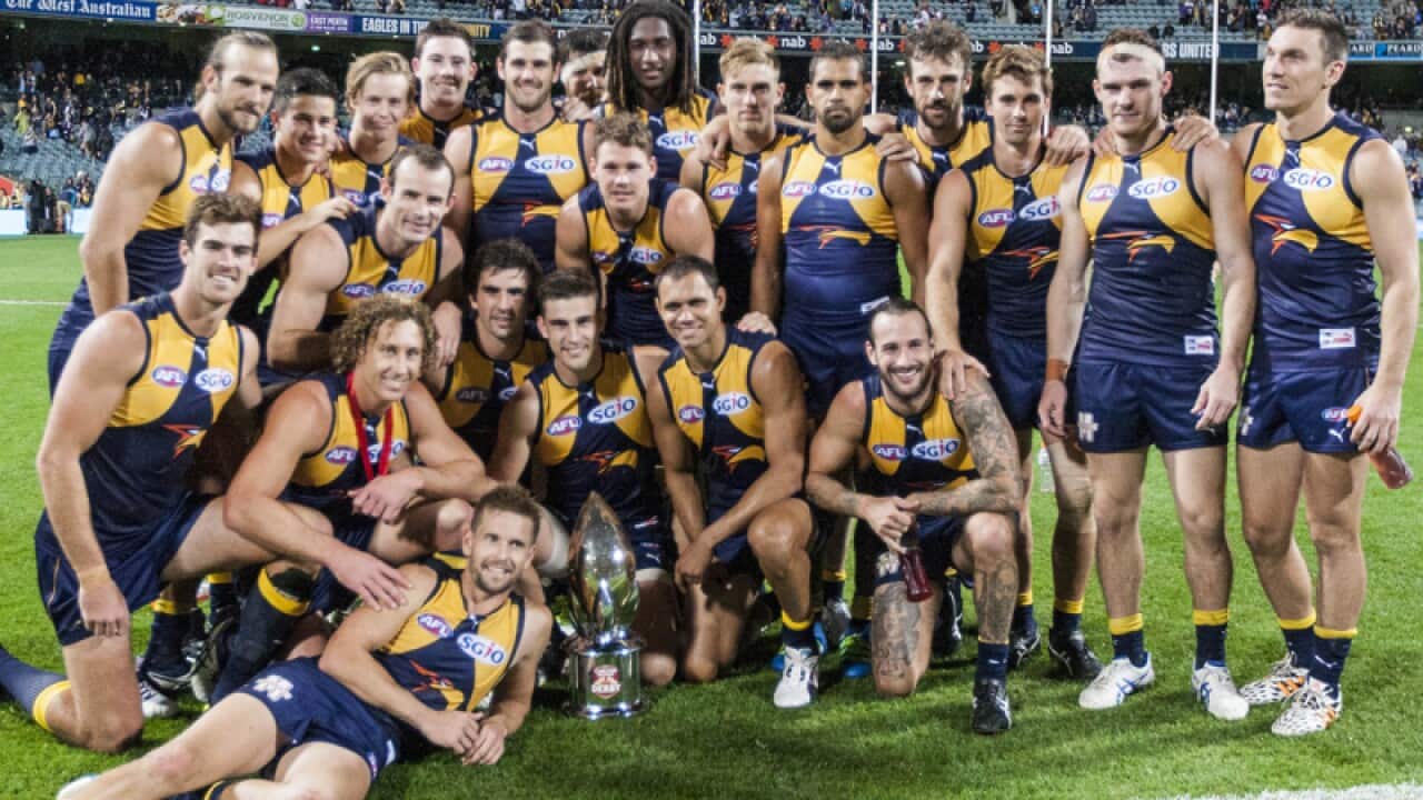 West Coast Eagles players celebrate with the derby trophy
