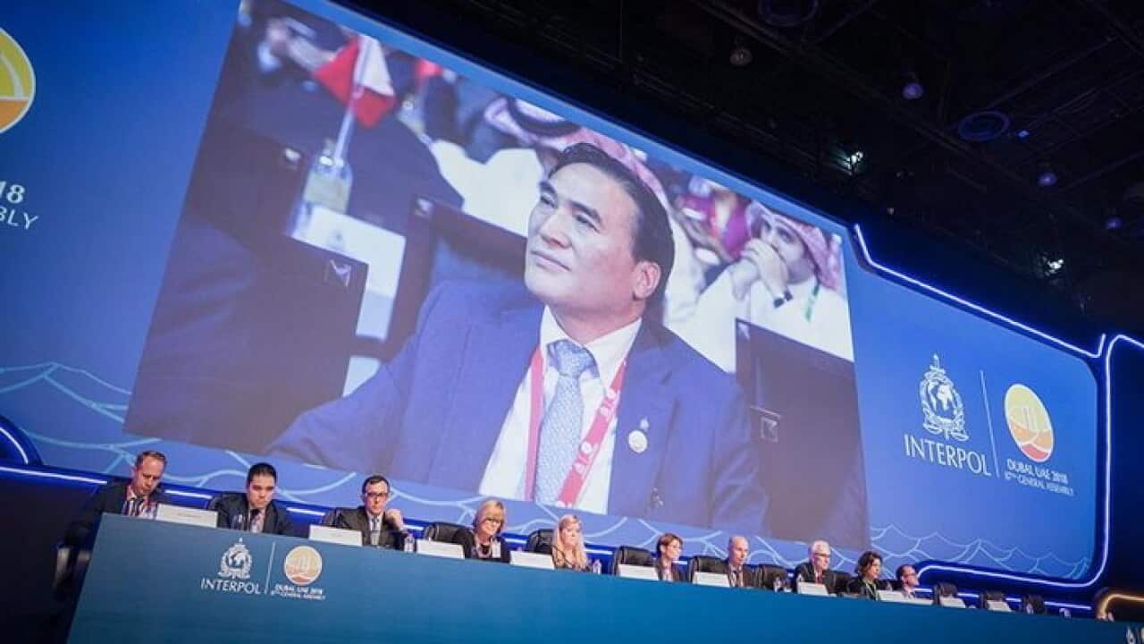 Kim Jong-yang's picture is flashed on the screen at the Interpol session