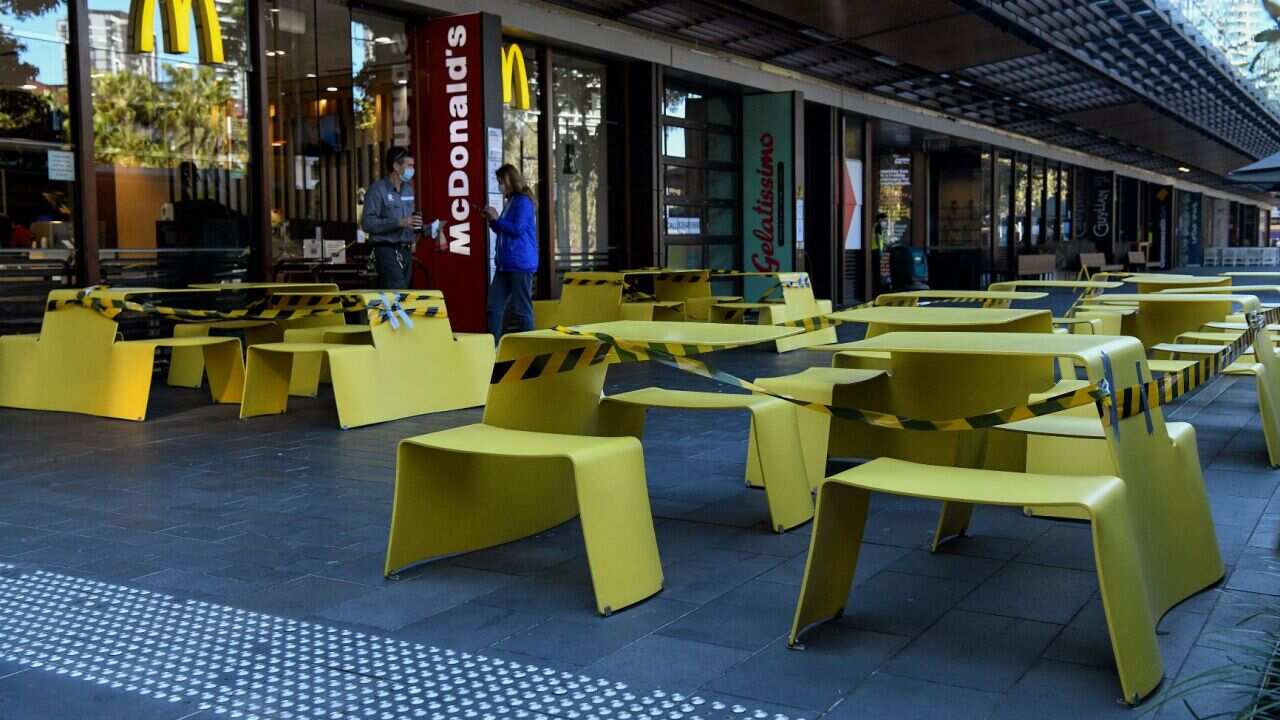 Chairs and tables are roped off to stop people from gathering at a fast food outlet in Sydney, Thursday, August 26, 2021.