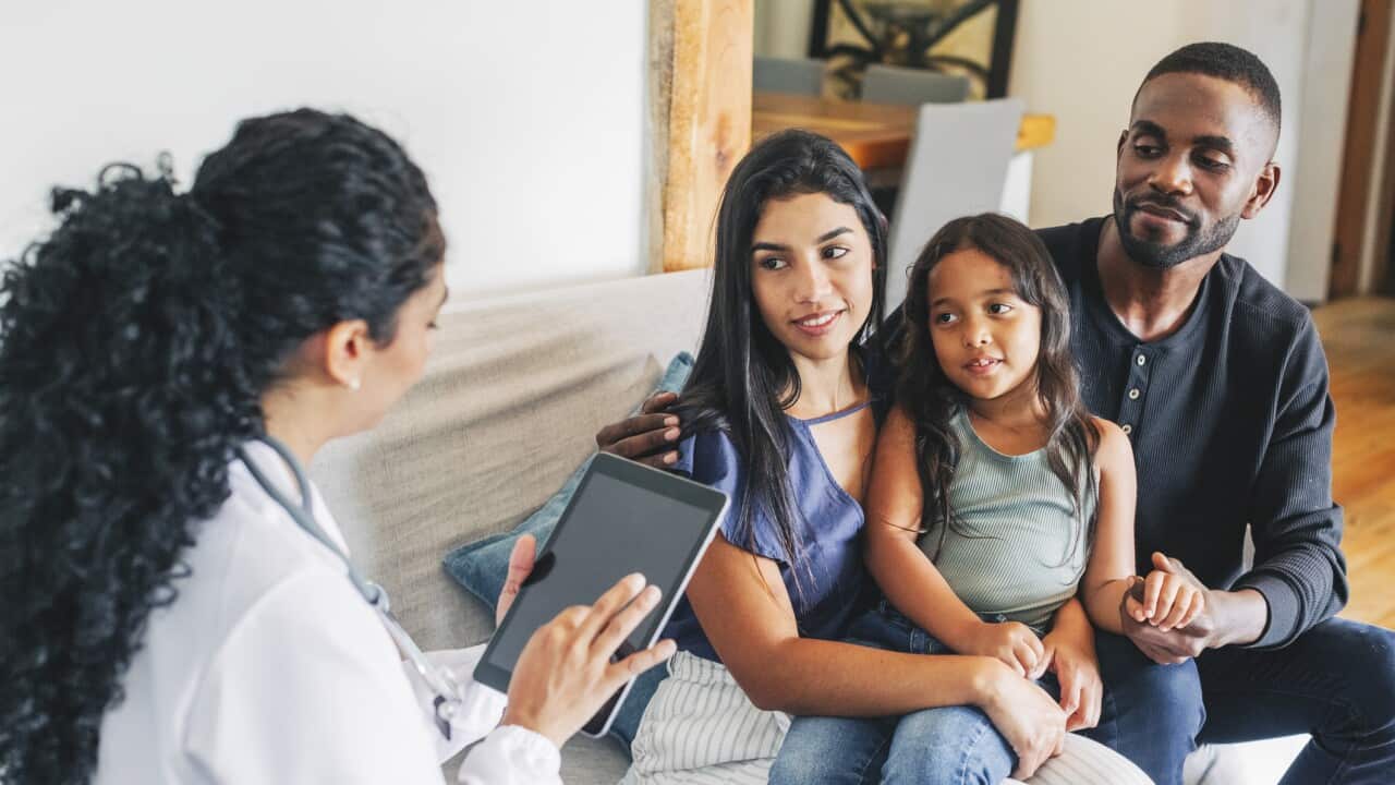 Young family getting medical consultation from doctor on house call