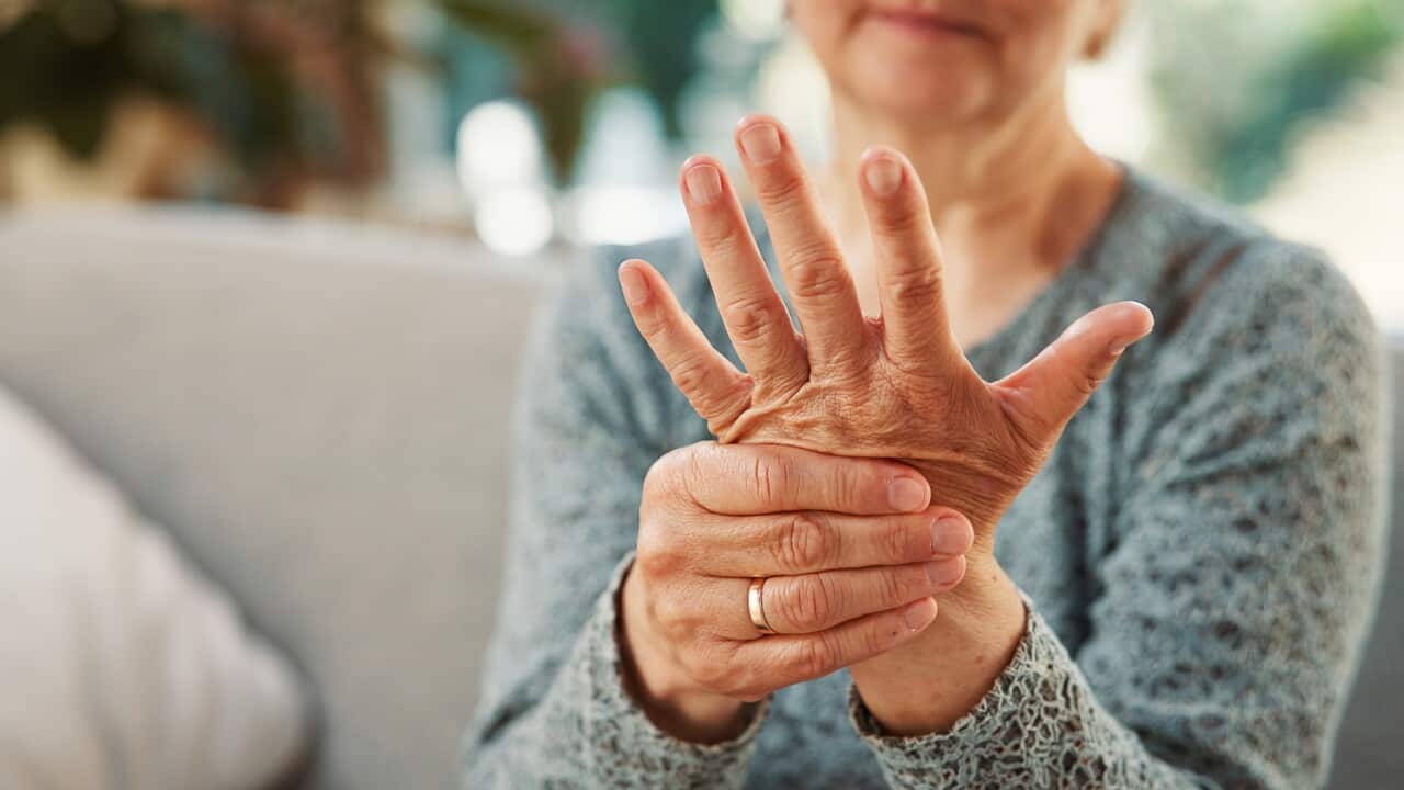 Arthritis, hands or elderly woman on couch with touch, joint pain or stiffness in finger movement. Tendinitis, space or senior person in house with ache, inflammation or hurt muscle in nursing home.