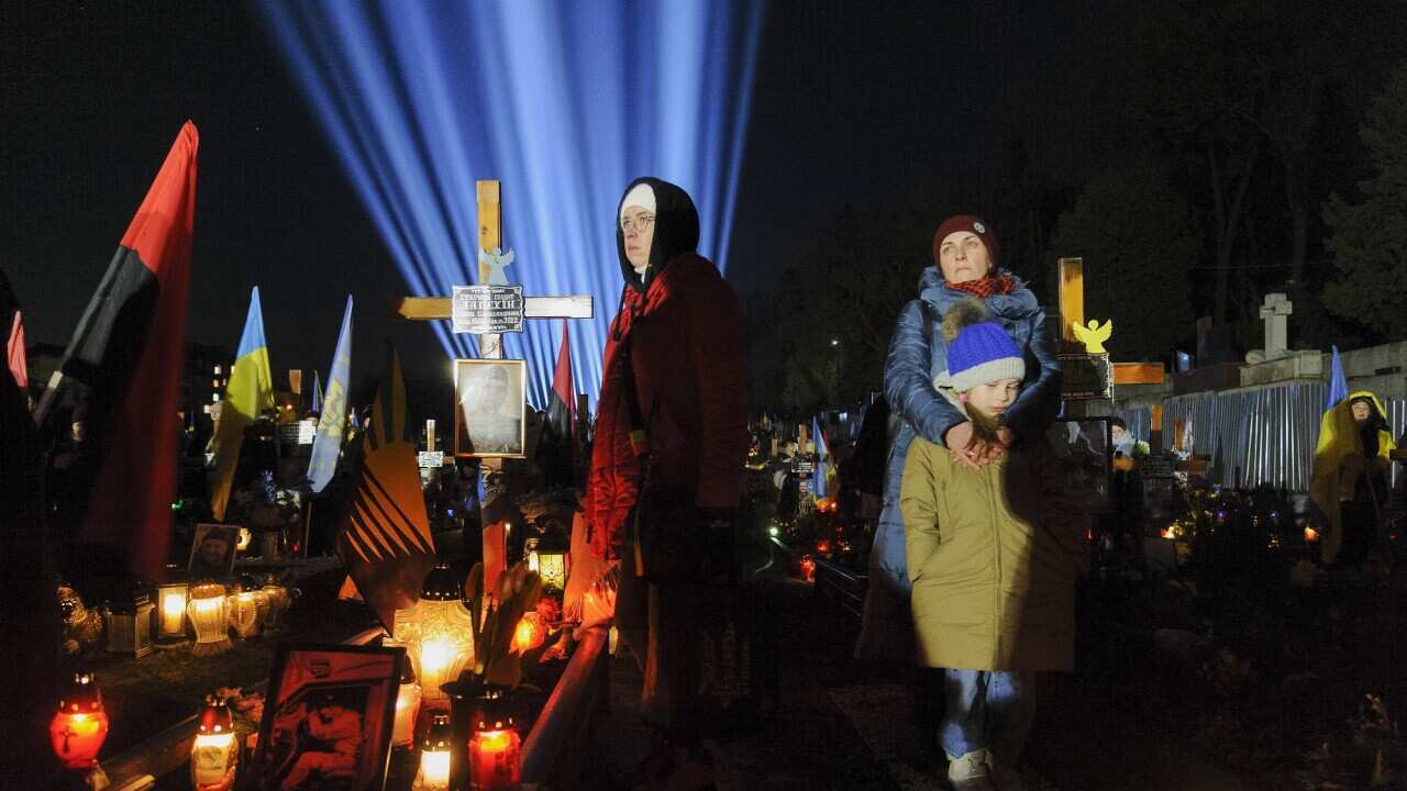 A vigil is held at Lychakiv military cemetery in Lviv to mark the first anniversary of the conflict. (Getty).