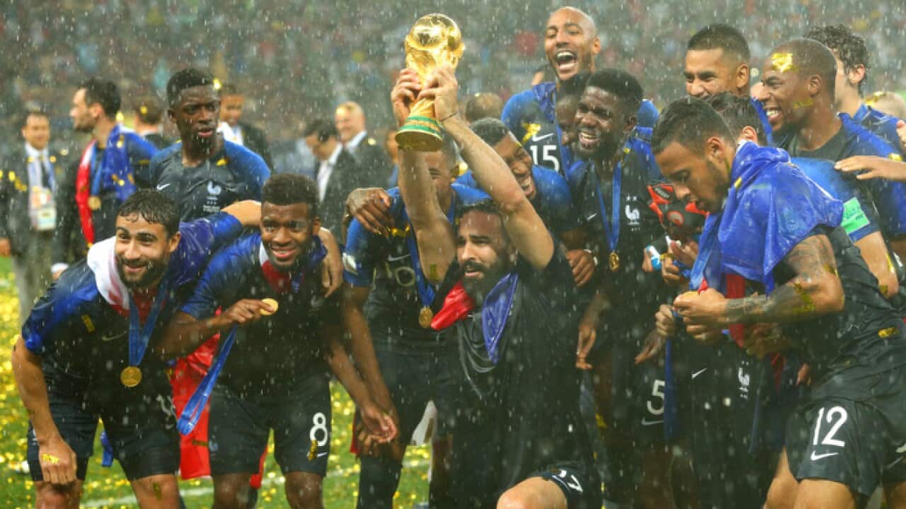 Adil Rami of France and his team-mates celebrate victory with the FIFA World Cup trophy (Getty)